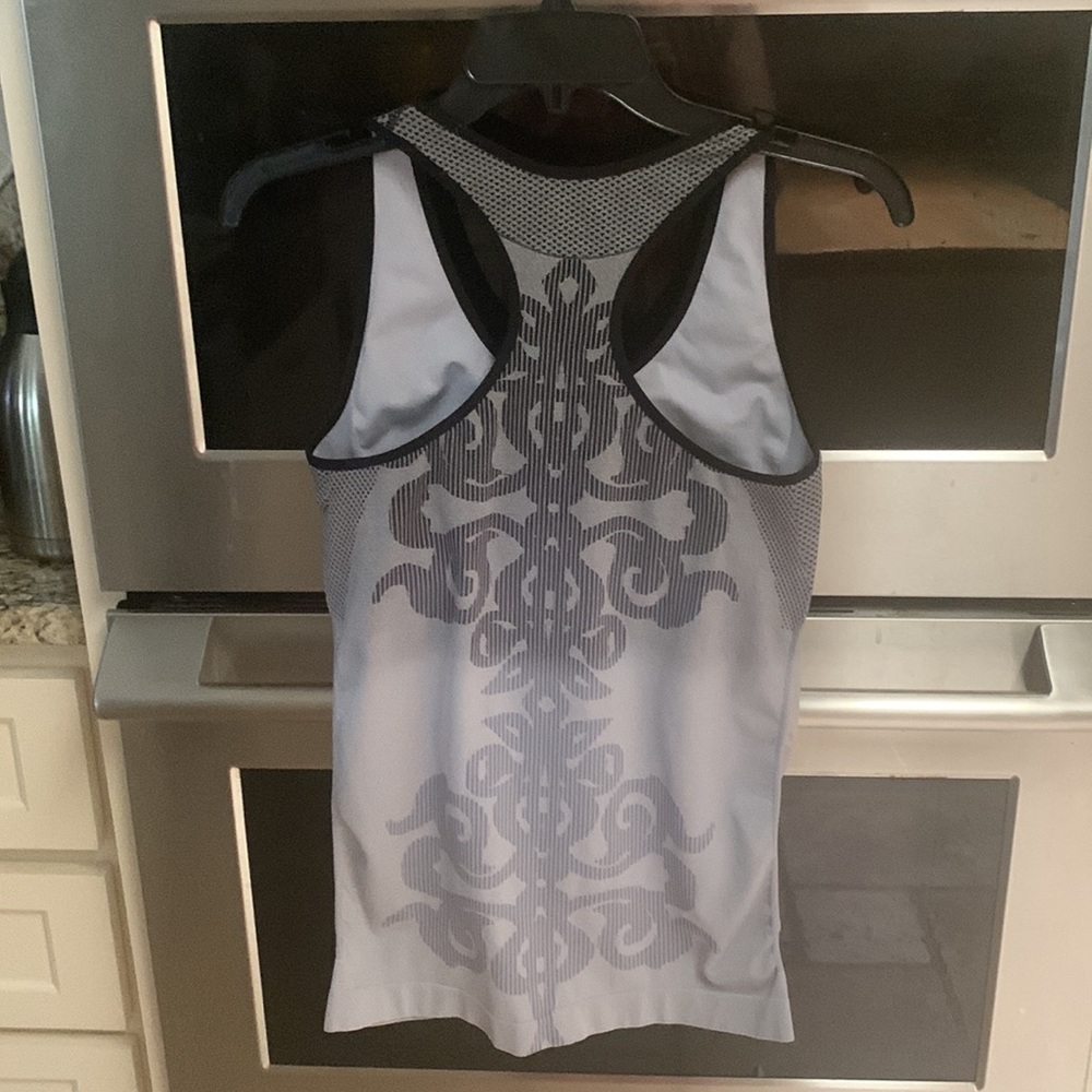 Climawear sports top with built in bra with removable pads. Size large long fit